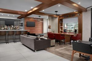 a lobby with a bar and a couch and a table at Fairfield Inn & Suites by Marriott New York Manhattan/Central Park in New York