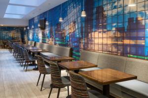 a row of tables and chairs in a restaurant at Fairfield Inn & Suites by Marriott New York Manhattan/Central Park in New York