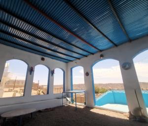 a room with a view of a pool with windows at Asilah kato nubian guest house in Aswan