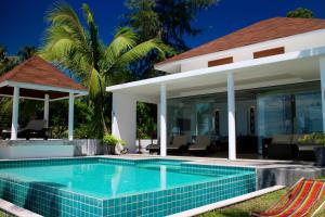 a swimming pool in front of a villa at Laemsor Residence in Laem Sor