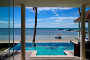 a view of the beach from a resort swimming pool at Laemsor Residence in Laem Sor