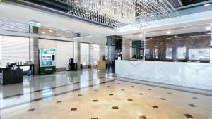 a lobby with a reception desk in a building at Delton Hotel in Kaohsiung