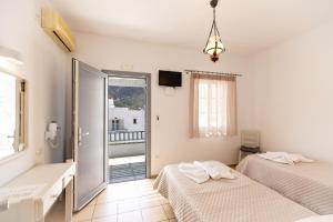 Ένα ή περισσότερα κρεβάτια σε δωμάτιο στο Litsa Rooms