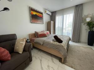 a bedroom with a bed and a couch at Hovah Luxury Suite in Accra