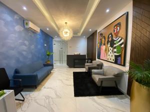 a lobby with couches and a painting on the wall at Hovah Luxury Suite in Accra