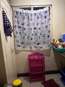 a window in a kitchen with a curtain on it at Drish Haven in Nairobi