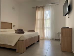 a bedroom with a bed with towels on it at Deda Apartments in Livadia