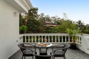 patio z krzesłami i stołem na balkonie w obiekcie Villa Hestia-3bed villa in Assagao By Masaya Stays w mieście Verla