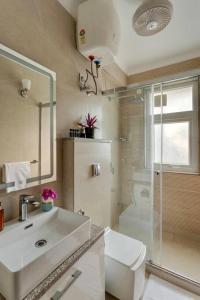 a bathroom with a sink and a toilet and a shower at Villa Hestia-3bed villa in Assagao By Masaya Stays in Verla