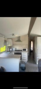 a kitchen with a stove and a counter top at 238 Arran View, Craig Tara Holiday Park in Ayr