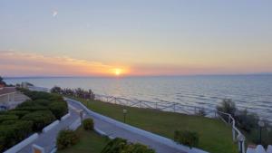 a sunset over the ocean at a resort at Acqua di Mare Hotel e Resort in Marina di Sorso +47 photos