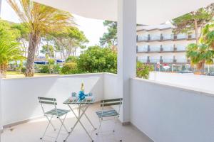 a balcony with a table and chairs and a building at Hugo 2 in Cala Ratjada