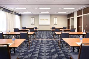 a conference room with tables and chairs and a whiteboard at Courtyard by Marriott Waterloo St. Jacobs in Waterloo