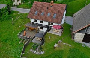 an overhead view of a house with a table and umbrella at Hisa Brdo Guesthouse in Tolmin