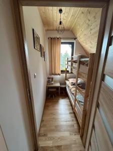 a room with two bunk beds and a window at FAMILY HAUSE in Witów