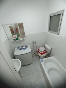 a bathroom with a tub and a toilet and a sink at Beachfront Villa 3bedrooms+3bathrooms in El Alamein