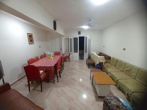 a living room with a couch and tables and chairs at Beachfront Villa 3bedrooms+3bathrooms in El Alamein