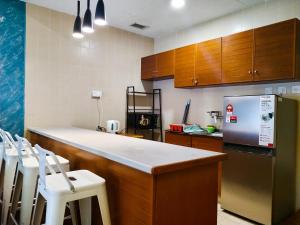 a kitchen with a counter top and a refrigerator at Regency Tanjung Tuan Beach PD by Idealhub in Port Dickson