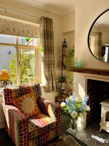 a living room with a couch and a fireplace at Beautiful 2-Bed Cottage in Heysham Village in Heysham