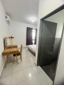 a room with a table and a bed and a door at 75 Suite (Tower B) in Papar