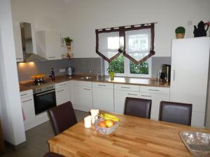 a kitchen with a table with a bowl of fruit on it at Relaxing Holiday Home in Willersdorf in the forest in Frankenberg