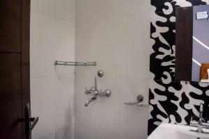 a bathroom with a shower and a sink at Budget Friendly 3 BHK + Prime Location in Faridabad