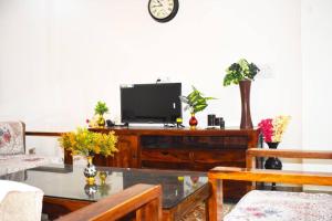 a living room with a tv on top of a table at Budget Friendly 3 BHK + Prime Location in Faridabad