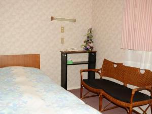 a bedroom with a bed and a chair and a table at Nara - Hotel / Vacation STAY 47950 in Nara