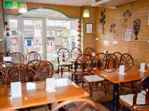 an empty restaurant with wooden tables and chairs at Nara - Hotel / Vacation STAY 47950 in Nara