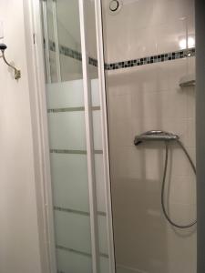 a shower with a glass door in a bathroom at Studio - Le Pouliguen in Le Pouliguen