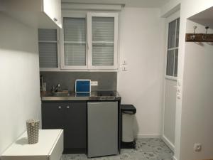 a small kitchen with a sink and a counter at Studio - Le Pouliguen in Le Pouliguen