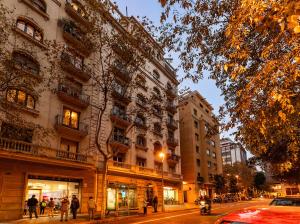 a group of people walking down a street next to buildings at Large & beautiful apartment 4min from Passeig de Gràcia in Barcelona
