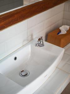 a white sink in a bathroom with a mirror at Catu Glamping Bedugul in Tabanan