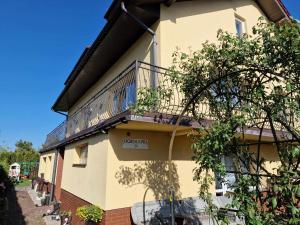a building with a balcony on the side of it at AGNES in Grzybowo