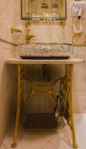 a bathroom with a sink and a mirror at THE HIDDEN BANK: Silver Bullet in Plovdiv