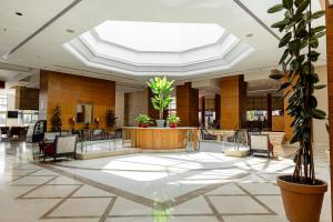 a lobby with chairs and a table in a building at Millennium Palestine Ramallah in Ramallah