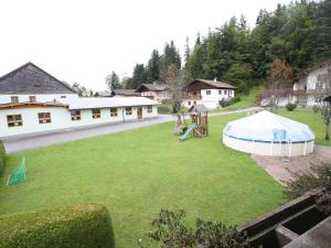a large yard with a tent and a playground at Scenic Apartment in Krispl Salzburg with Swimming Pool in Krispl
