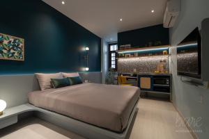 a bedroom with a large bed and a kitchen at Bare Hyphen - Bare Boutique Stays in Ho Chi Minh City