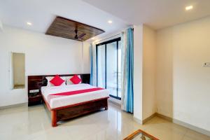 a bedroom with a bed and a large window at OYO Comfort lodging and boarding in Kalyan