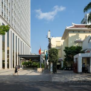 a person walking down a street in a city at Bare Hyphen - Bare Boutique Stays in Ho Chi Minh City
