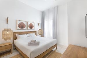 a white bedroom with a bed with a tray on it at Ocean Grand Gaube by Host Agents in Grand Gaube +26 photos
