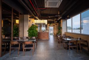 a restaurant with tables and chairs and a bar at Hato Saigon Boutique Hotel & Rooftop in Ho Chi Minh City
