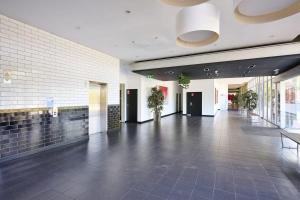 a lobby with a tile floor and a building at Gallop to Your Getaway! in Melbourne