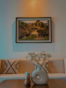 a painting hanging on a wall above a couch at Morika Villa in Rua
