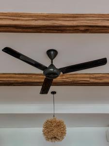a ceiling fan hanging from a ceiling at Morika Villa in Rua