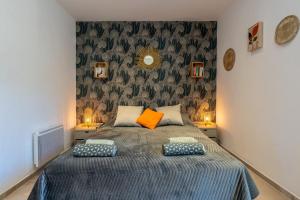 una camera con un letto con due cuscini sopra di Mas de Liam - Maison de plain-pied climatisée a Comps