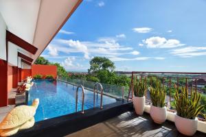 a swimming pool on the balcony of a building at Four Star by Trans Hotel in Sanur