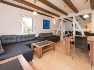 a living room with a couch and a table at Modern group of homes close to Willingen and Winterberg with large garden in Medebach