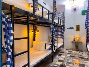 a room with bunk beds in a hostel at Stop And Go Lang Chai Boutique Resort in Phan Thiet