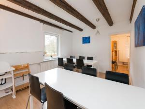 a meeting room with a white table and chairs at Modern group of homes close to Willingen and Winterberg with large garden in Medebach